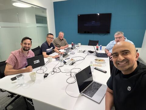 Spej colleagues working together around a conference table